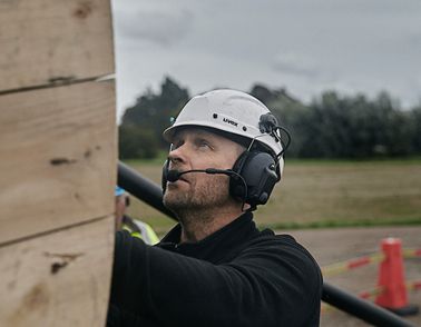 Cable installer pulling high voltage onshore cable from drum