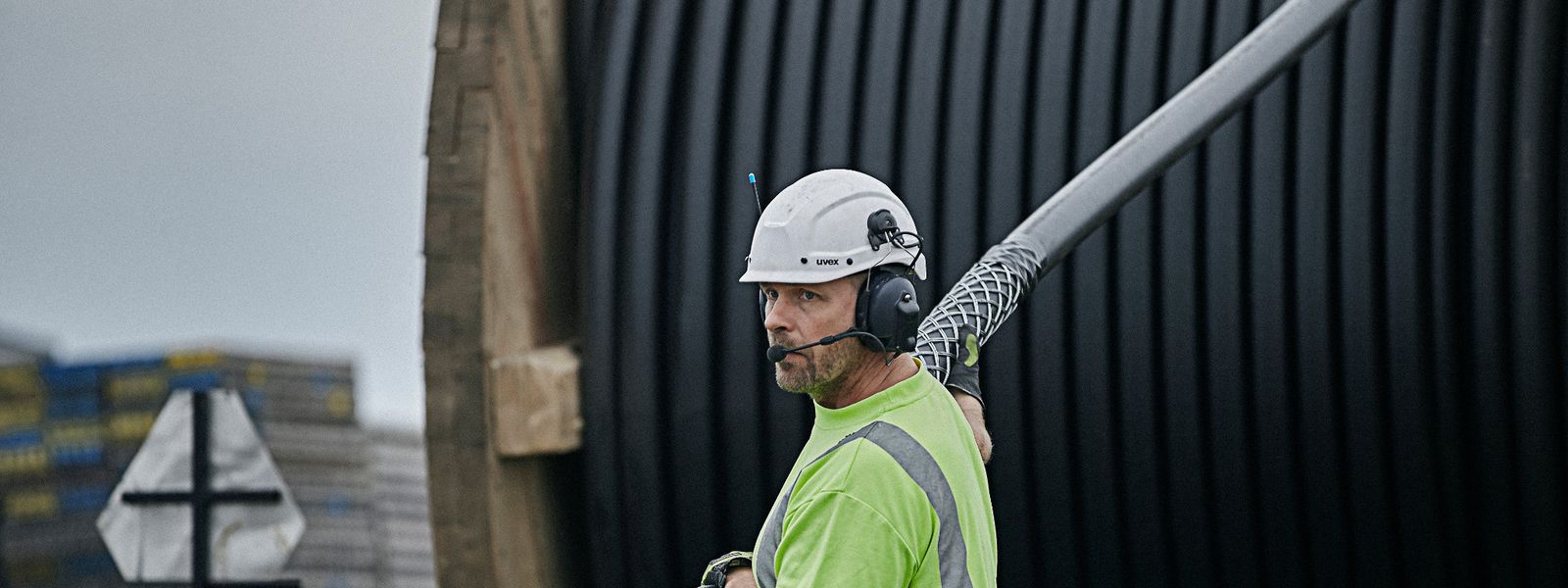 Cable worker pulling high voltage cable from a drum at onshore installation site in Trelleborg
