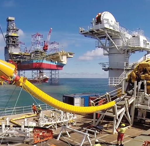 Cable laying vessel NKT Victoria installing an offshore cable with platform Martin Linge in the background