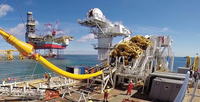 Cable laying vessel NKT Victoria installing an offshore cable with platform Martin Linge in the background